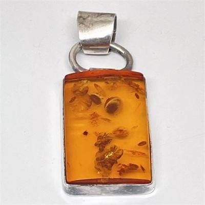 Lot 009  
Sterling Silver Seed Filled Amber Pendant