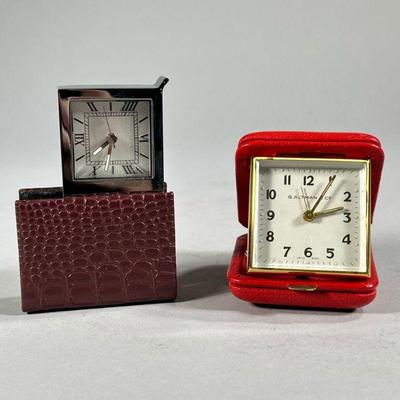 (2PC) LEATHER BOUND TRAVEL CLOCKS | Includes: B. Altman travel clock in red leather case, and other leather bound travel clock