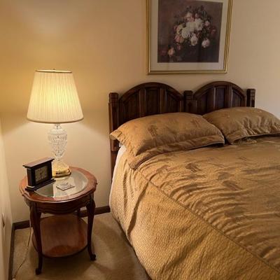 Queen sized bed includes faux wood headboard, metal, bedframe, boxspring, and mattress.
