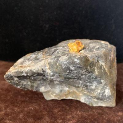 Natural gold nugget on rock