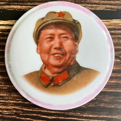 A collection of Chinese Communist porcelain propaganda pins and pendants, featuring Mao, peasants, soldiers and others, dating from...