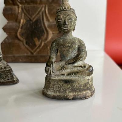 A collection of 18th century bronze and wood Thai Buddha figures
