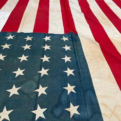 Huge early 48 star American flag, 8â€™ x 15â€™, all stitched with appliquÃ© stars, some minor water stains, c 1912-1917, around 1918...
