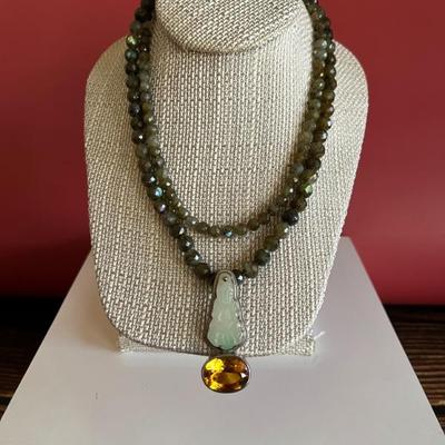 Double strand of faceted green garnets with an antique jade and large topaz pendant set in silver
