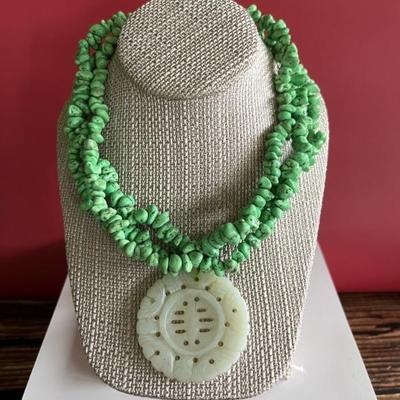 Multi strand green turquoise necklace with an antique jade pendant