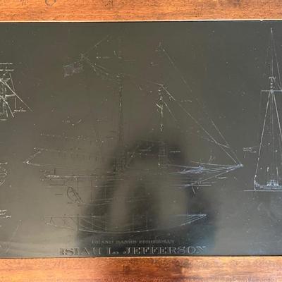 mid century coffee table with slate top engraved with the schematics of a ship