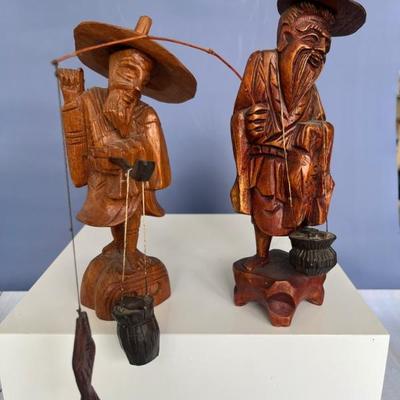 pair of carved wooden Chinese fisherman figurines