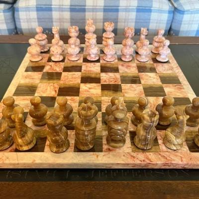 And speaking of chess, a beautiful carved chess set in pink marble and bronze agate with a matching board
