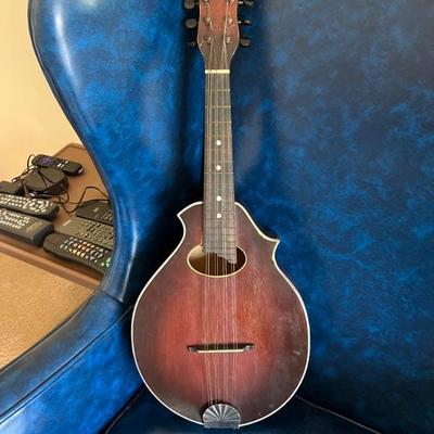 Vintage musical instruments  including a Harmony ukulele, a mandolin, and bongo drums