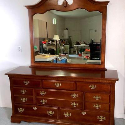 NIAB215 Dresser With Mirror	Solid wood dresser with mirror and 8 drawers with brass handles. Top of the dresser has a little bit of...