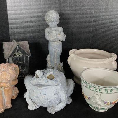 NIAB811 Garden Art And Flower Pots	Assortment of garden art and flower pots. Includes sleeping and standing cherubs, frog statue, and two...