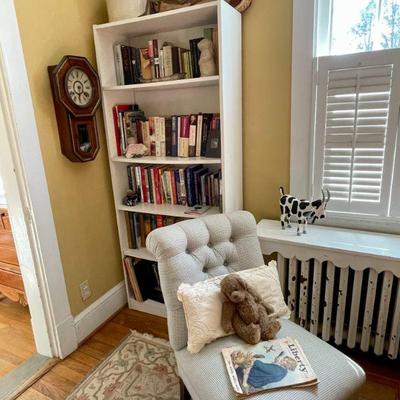 One of two Kellogg Collection tufted accent chairs on casters