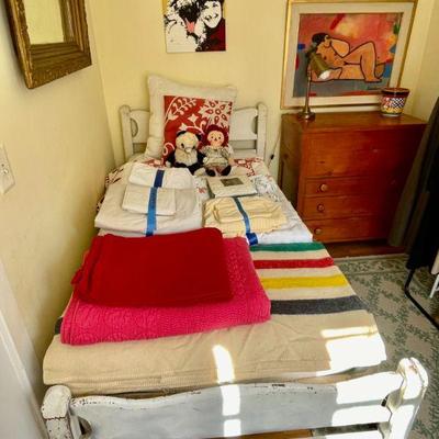 Twin bed with twin-size linens, and vintage four-stripe blanket