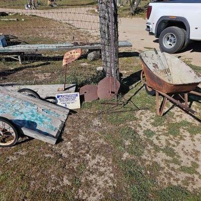 #1242 â€¢ Wheel Barrow, Tractor Seat, Cart, Rakes, Sign and Stands

