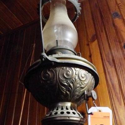 Iron frame, embossed brass lamp, original chimney.  Excellent condition