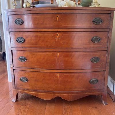 Antique Bowfront chest with 4 graduating drawers and inlay.