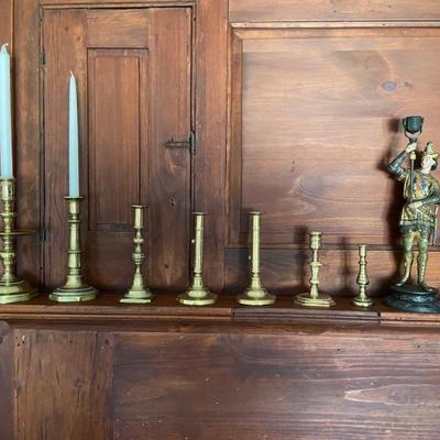 Lots and lots of pairs of antique candlesticks