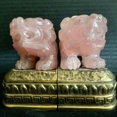 HAYE803 Rose Quartz Foo Dog Bookends	Pair of Rose Quartz Foo Dog Bookends on solid brass base. Carving is attached to base via brass pin.Â 
