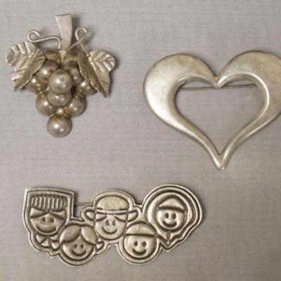 1252	MEXICO STERLING SILVER PIN ASSORTMENT INCLUDING GRAPE CLUSTER MARKED GL-SL AND THE FACES MARKED SAVE THE CHILDREN. 1.7 TOZ
