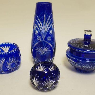 1052	BOHEMIAN GLASS COBALT CUT TO CLEAR 4 PC. ASSORTMENT INCLUDING VASE, COVERED DISH AND SMALL BOWLS, TALLEST PIECE APPROXIMATELY 9 IN H
