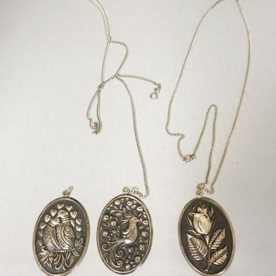 1243	3 INTERNATIONAL STERLING PENDANTS, 2 WITH CHAINS. PENDANT APPROXIMATELY 2 1/2 IN X1 1/2 IN W, 1.54 TOZ. CHAINS NOT MARKED
