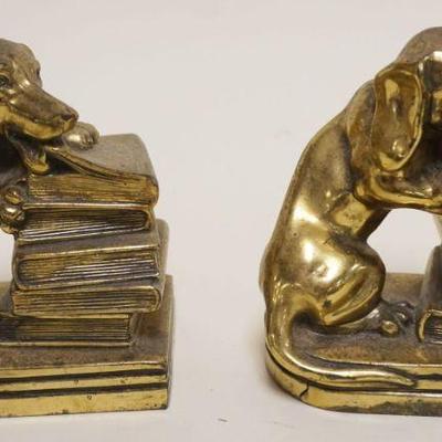 1022	PAIR OF CAST METAL DOG BOOKENDS DEPICTING A DOG CHEWING ON A STACK OF BOOKS, EACH APPROXIMATELY 3 IN X 4 IN X 5 IN H
