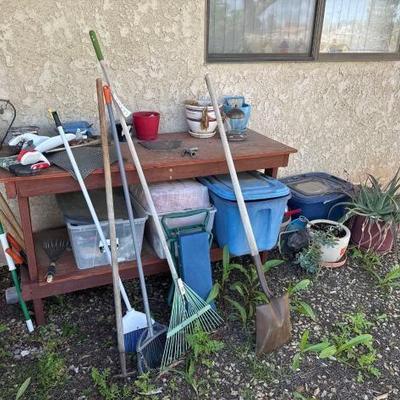 #10000 â€¢ wood bench with yard tools and plastic totes gardening stuff
