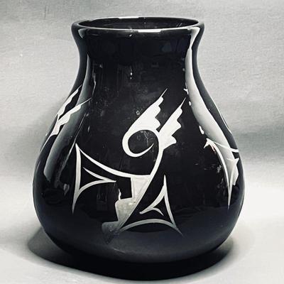  sleek black vase features unique etched Native American designs, and glossy finish. 