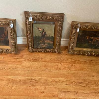 Old gilded frames with prints