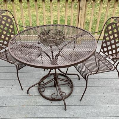 Outdoor iron patio table and pr. of chairs. Umbrella in garage.
