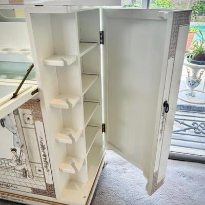 Ivory chinoiserie pulldown wet bar. Both sides open to hold wine glasses, bottom opens to hold bottles, and top opens for bar. 