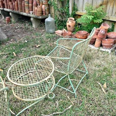 Vintage green metal set, including chaise lounge, two chairs with connecting round table with umbrella holder, and side table