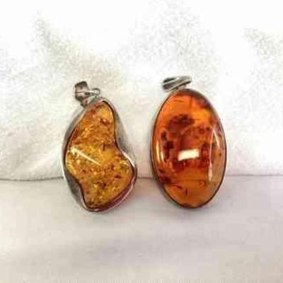 HAYE121 Two Large Baltic Amber, Sterling 925, Pendants	Two different colored pieces, both stamped 925. Each measure about 2 inches. 
