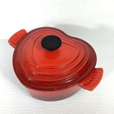 DILA701 Le Creuset Enameled 2 Liter Dutch Oven	A heart shaped, vibrant red, enameled Le Creuset 2 liter Dutch oven, manufactured in...