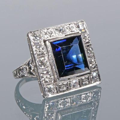 ANTIQUE SAPPHIRE & DIAMOND RING | Designed as a synthetic blue sapphire bezel mounted in a border of colorless melee diamonds in an...