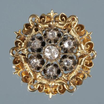 ANTIQUE FLOWER HEAD BROOCH | Designed as a round gold openwork gallery with engraved scrolls, ropework, and fleur-de-lis, the center...
