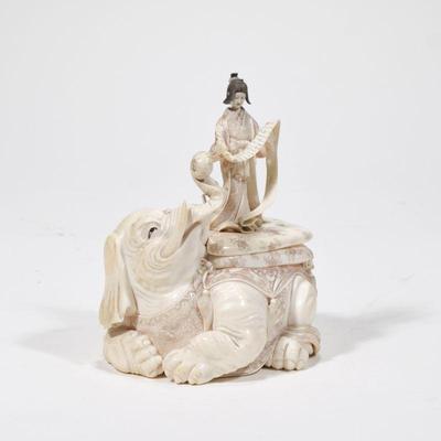 JAPANESE CARVED FIGURAL GROUP BOX | Antique carved ivory, the box intricately carved in the form of a resting elephant, the conforming...