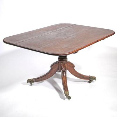 ANTIQUE ENGLISH TILT-TOP BREAKFAST TABLE | 19th century, Rams Head mounted casters, carved quadruped base, turned support. - l. 56.5 x w....