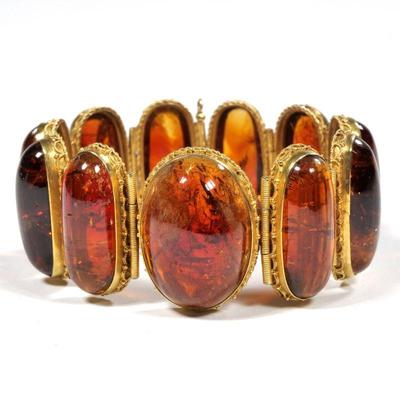 ANTIQUE AMBER TOURMALINE LINK BRACELET | having ten well-matched links of oval amber tourmaline cabochons (29 x 12 x 7 in., each approx.)...
