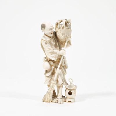 JAPANESE FIGURAL CARVING | Ivory carving showing a man holding a basket with a leaves and a rodent, holding a broom and standing beside a...