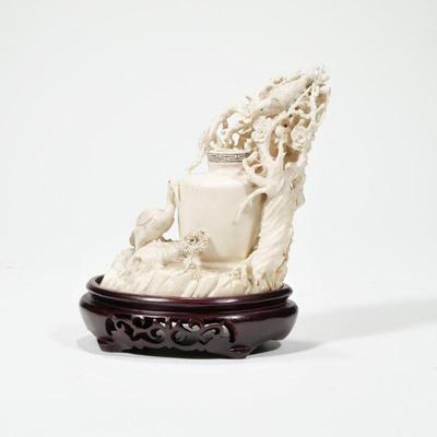 CHINESE CARVED FIGURAL GROUP | 19th century, carved ivory, showing birds among flowering reticulated branches with a central carved vase...