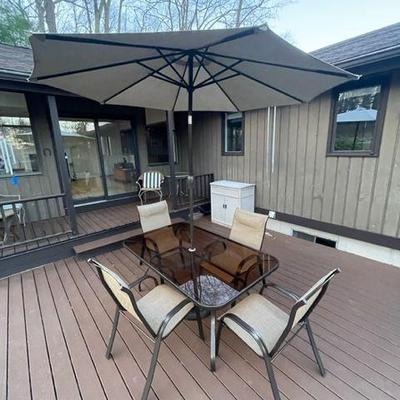 Beautiful outdoor patio set, smoky glass table top and 4 chairs and shade umbrella.  Just in time for summer.