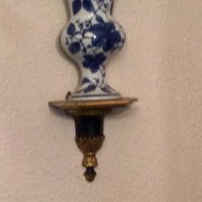 Blue and white vases on wall sconce