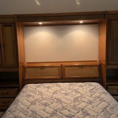 Large headboard Wall Unit with two reading lights on top; hutch storage at top, shelves, drawers, and cabinets all inclusive in this...