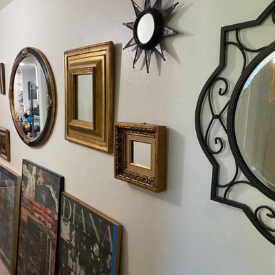 Assortment of mirrors and art in hallway
