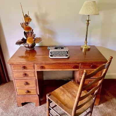 Lot 028-BR2: MC Student Desk Vignette

Features: 
â€¢	Small mid-century wooden desk, typewriter, brass table lamp, ladderback chair and...