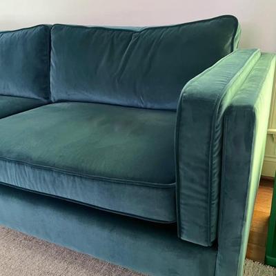 Details of a 3 seater teal green sofa.