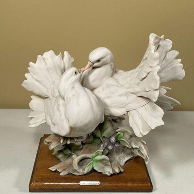 G. ARMANI DOVE SCULPTURE | Two dove ceramic depiction on wooden base. Engraved with Armani name on base of ceramic. - dia. 9 in

