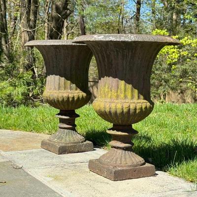 PAIR OF ANTIQUE CAST IRON GARDEN URNS | Matched pair of late 19th/ early 20th century cast iron garden urns with gadrooning and other...