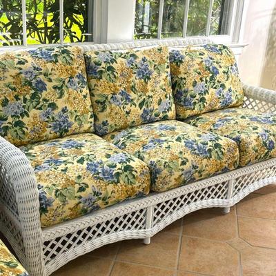WICKER SOFA | Painted white wicker sofa featuring 3 cushioned seats. - l. 77 x w. 32 x h. 36 in

